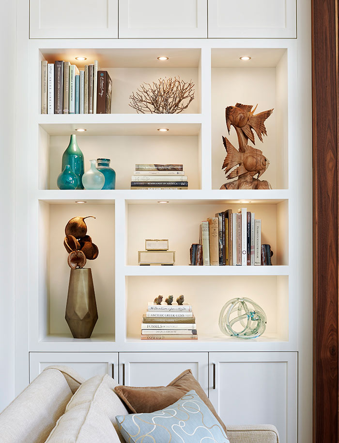 A beautifully designed clutter free living room cabinet with books and accessories.