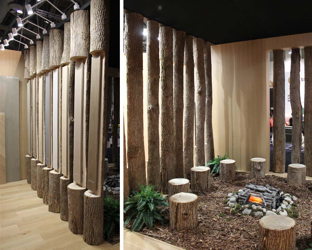The PurParket booth at IDS 2020 with stumps around a faux campfire and taller logs to display the wood flooring.