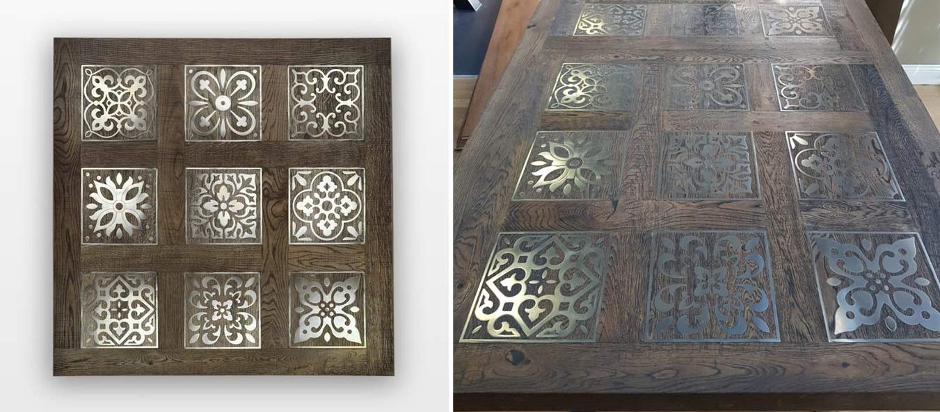 A section of wood flooring with 9 decorative metal inlays designed into the top of a table.