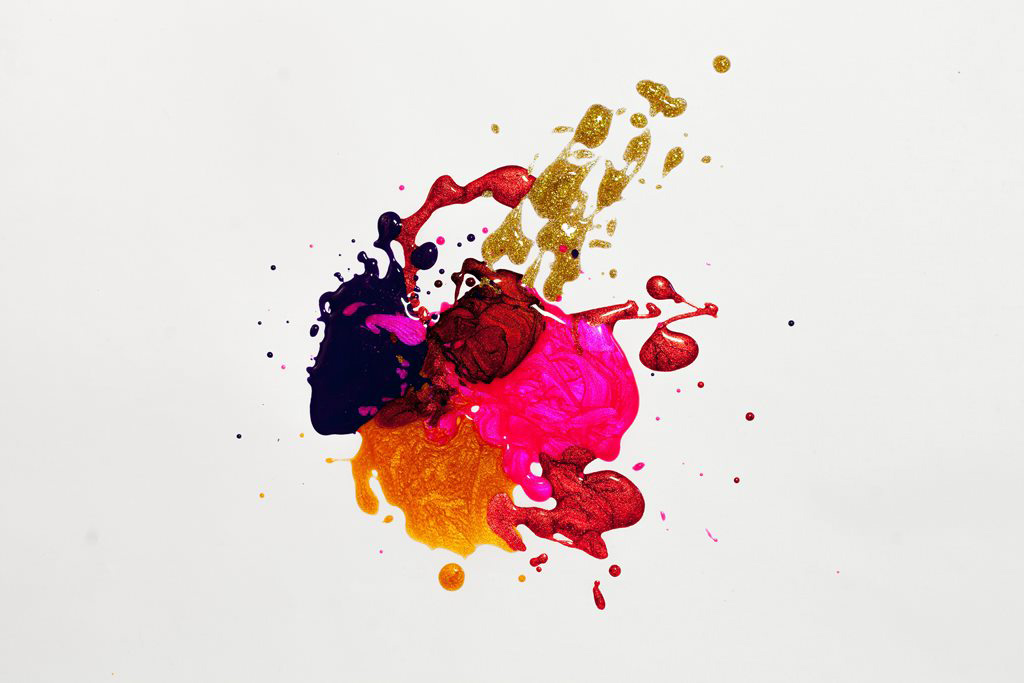 A multi coloured splatter of iridescent paint on a white background.